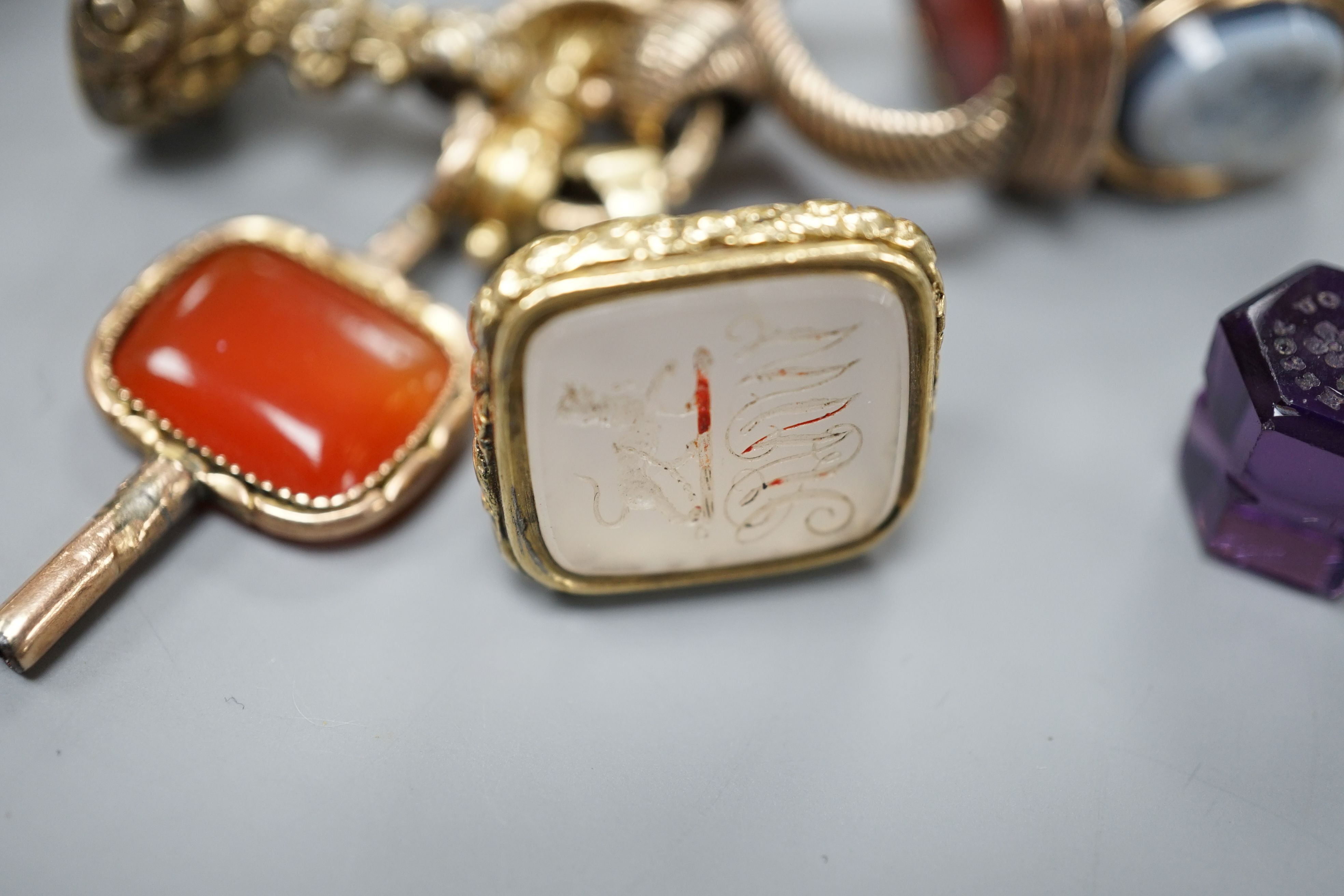 Eight assorted 19th century and later fob seals including a rose diamond set black glass dog with Roman head intaglio, 3cm, a gold overlaid and watch key